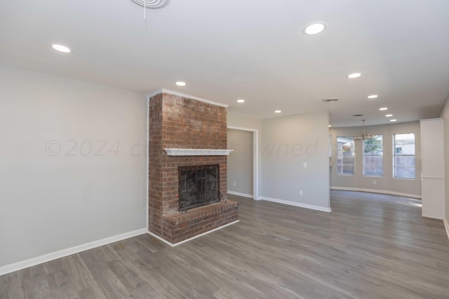 unfurnished living room featuring a fireplace and hardwood / wood-style flooring