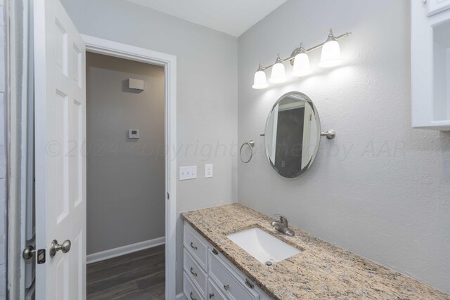 bathroom featuring vanity and hardwood / wood-style flooring