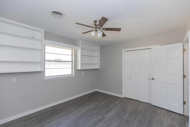 unfurnished bedroom featuring dark wood-type flooring, ceiling fan, and a closet