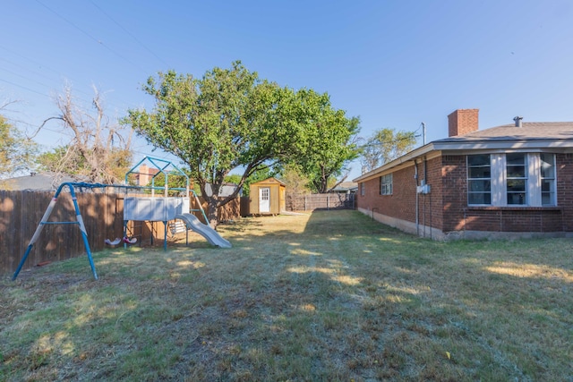 view of yard with a playground and a shed