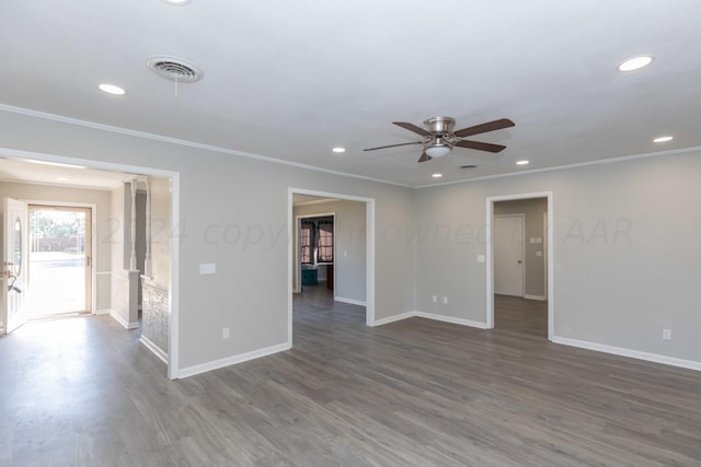 empty room with ornamental molding, dark hardwood / wood-style flooring, and ceiling fan