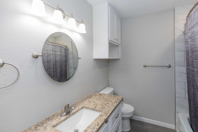 full bathroom featuring shower / bath combo with shower curtain, vanity, hardwood / wood-style flooring, and toilet