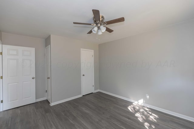 unfurnished bedroom with dark hardwood / wood-style flooring, ceiling fan, and a closet