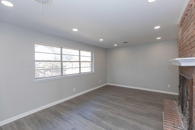 unfurnished living room with dark hardwood / wood-style flooring and a fireplace