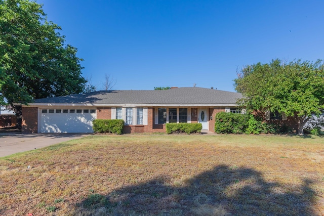 ranch-style home with a garage and a front yard