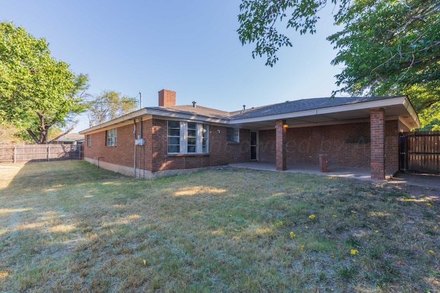 view of front of house featuring a front lawn and a patio area