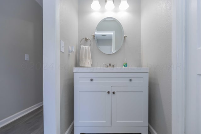 bathroom with vanity and hardwood / wood-style flooring