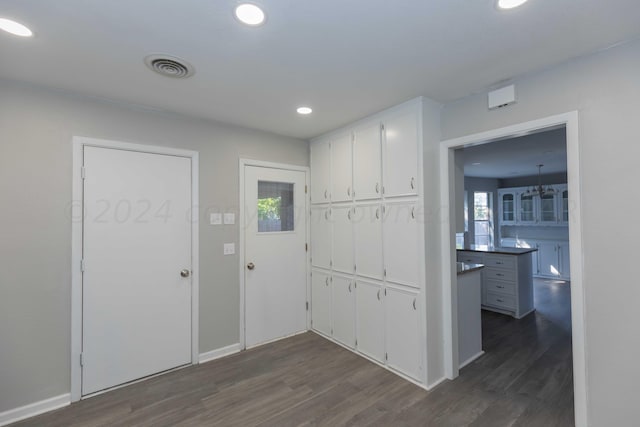 kitchen featuring white cabinets and dark hardwood / wood-style flooring