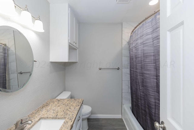 full bathroom featuring shower / bath combo with shower curtain, vanity, hardwood / wood-style flooring, and toilet