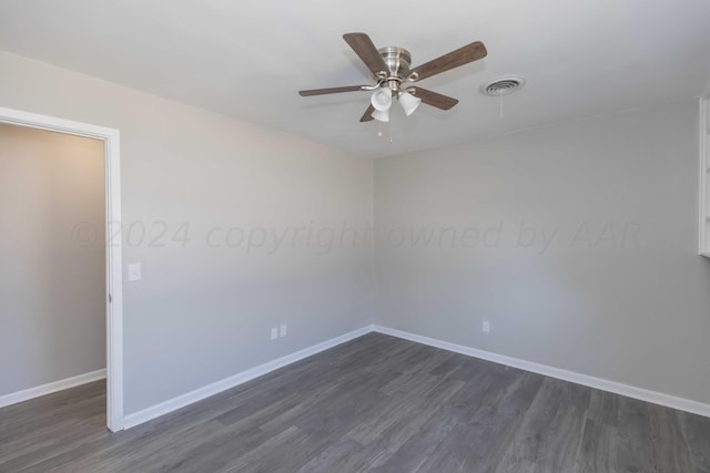 empty room with ceiling fan and dark hardwood / wood-style floors