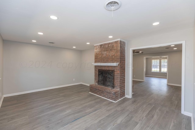 unfurnished living room featuring a fireplace and wood-type flooring