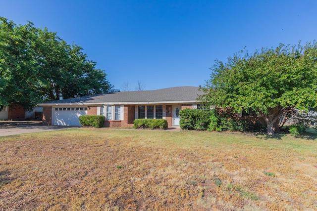 ranch-style home featuring a garage and a front lawn