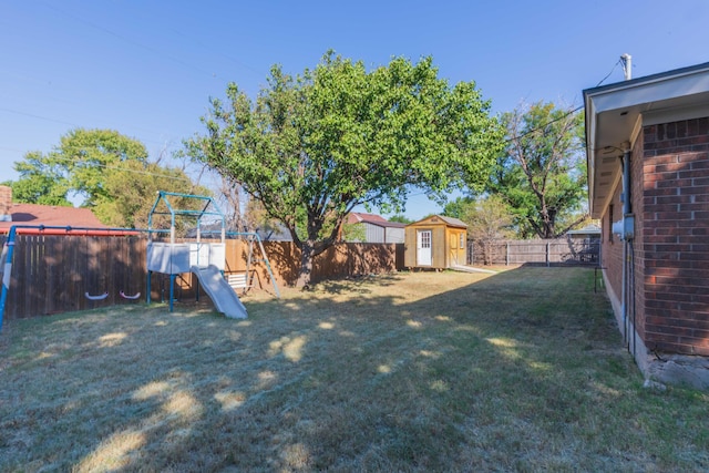 view of yard featuring a playground and a storage shed