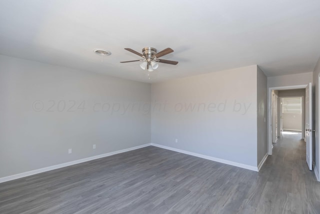 unfurnished room featuring dark hardwood / wood-style flooring and ceiling fan