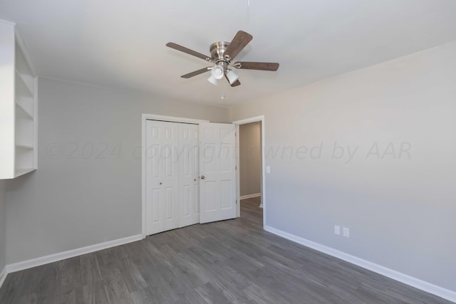 unfurnished bedroom with dark hardwood / wood-style flooring, ceiling fan, and a closet