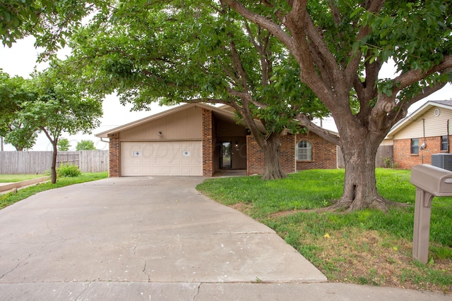 4818 SE 33rd Ave, Amarillo, TX 79103 - view of front of house with driveway, brick siding, and an attached garage