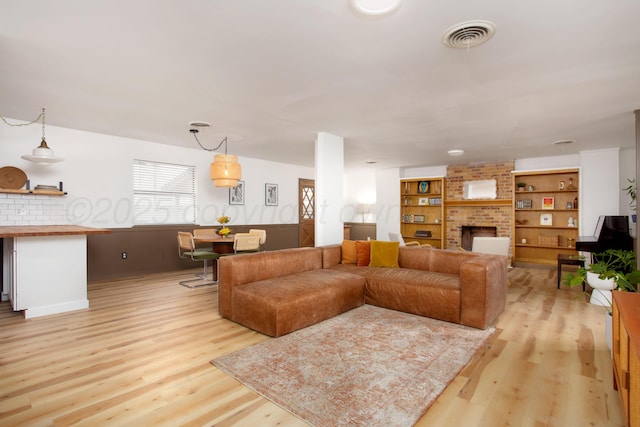 4818 SE 33rd Ave, Amarillo, TX 79103 - living area with light wood finished floors, a fireplace, and built in features