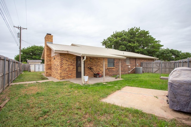 4818 SE 33rd Ave, Amarillo, TX 79103 - back of property featuring a chimney, a patio area, a fenced backyard, and brick siding