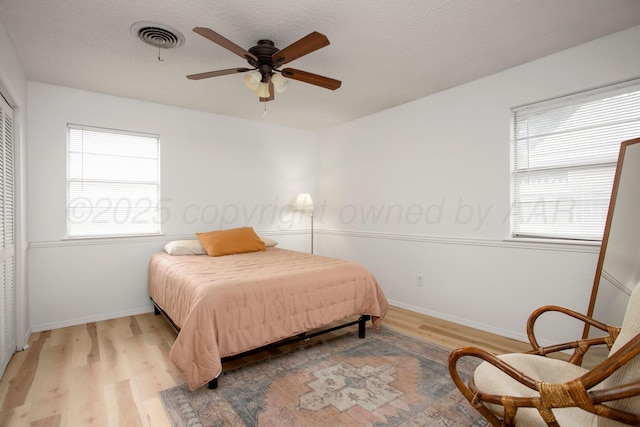 4818 SE 33rd Ave, Amarillo, TX 79103 - bedroom with light wood-style flooring, multiple windows, a ceiling fan, and a closet