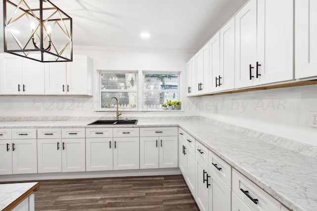 818 N Someville St, Pampa, TX 79065 - kitchen with crown molding, white cabinetry, dark wood-style floors, and a sink