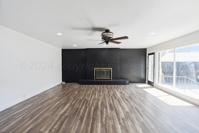 818 N Someville St, Pampa, TX 79065 - unfurnished living room featuring a ceiling fan, brick wall, a brick fireplace, wood finished floors, and recessed lighting