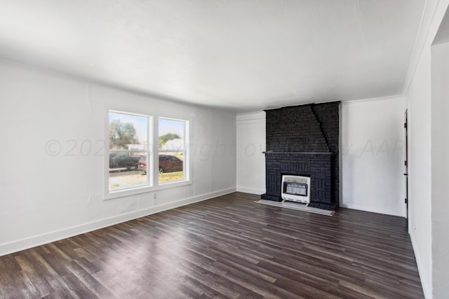 818 N Someville St, Pampa, TX 79065 - unfurnished living room with baseboards, a brick fireplace, and dark wood-type flooring