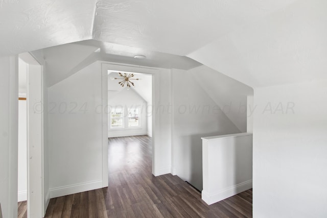 818 N Someville St, Pampa, TX 79065 - additional living space featuring baseboards, vaulted ceiling, and dark wood-style flooring