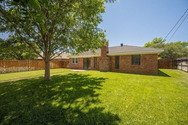 7935 Mitcham Dr, Amarillo, TX 79121 - rear view of house with brick siding and a chimney
