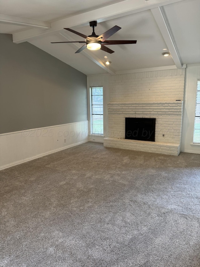 7935 Mitcham Dr, Amarillo, TX 79121 - unfurnished living room with carpet floors, a ceiling fan, a brick fireplace, and a wainscoted wall