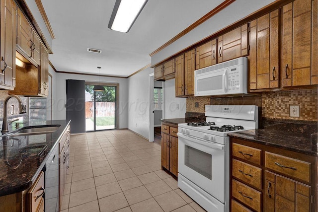 7935 Mitcham Dr, Amarillo, TX 79121 - kitchen featuring white appliances, a sink, ornamental molding, brown cabinetry, and decorative backsplash