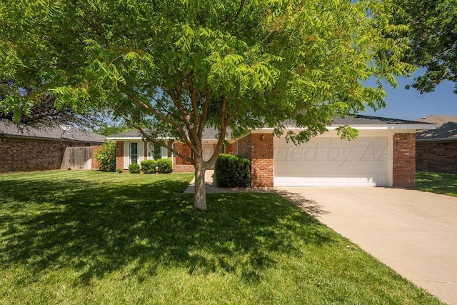 7935 Mitcham Dr, Amarillo, TX 79121 - view of front of house with brick siding, driveway, and a garage