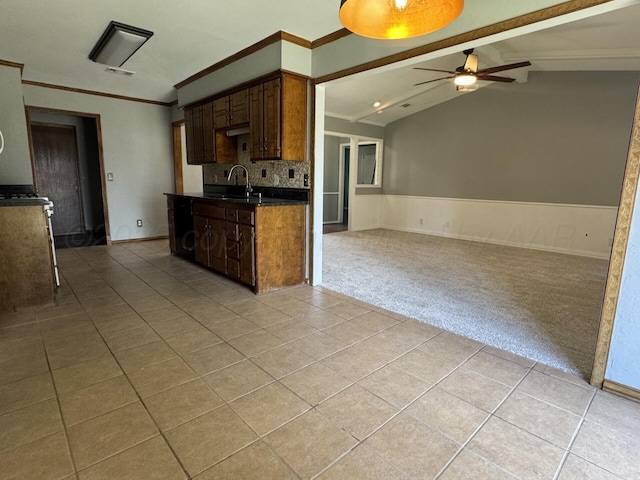 7935 Mitcham Dr, Amarillo, TX 79121 - kitchen featuring light tile patterned flooring, dark countertops, a ceiling fan, ornamental molding, and decorative backsplash
