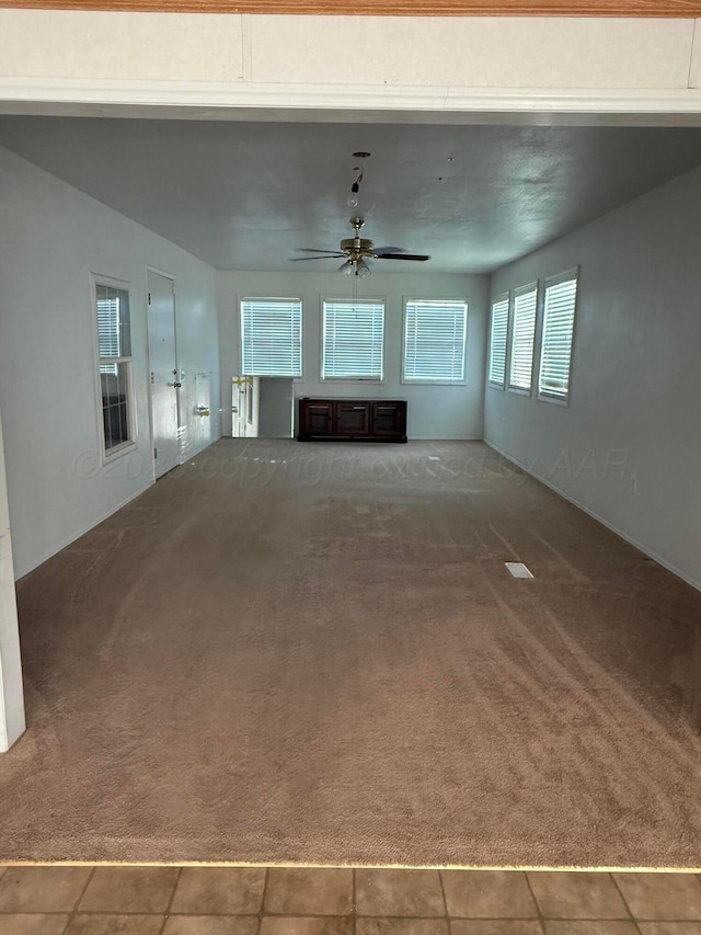 1046 S Farley St, Pampa, TX 79065 - unfurnished living room featuring a ceiling fan, carpet, and tile patterned floors