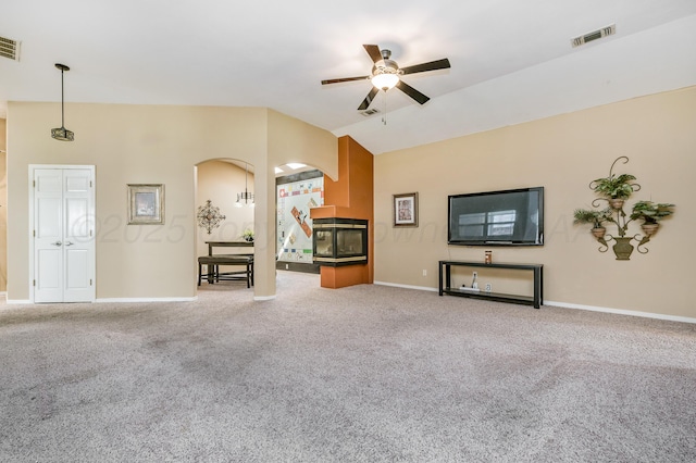7504 Aspire Pl, Amarillo, TX 79119 - unfurnished living room featuring a ceiling fan, vaulted ceiling, arched walkways, and carpet floors