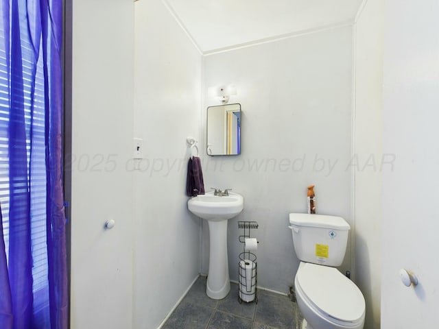 half bath with toilet and tile patterned flooring