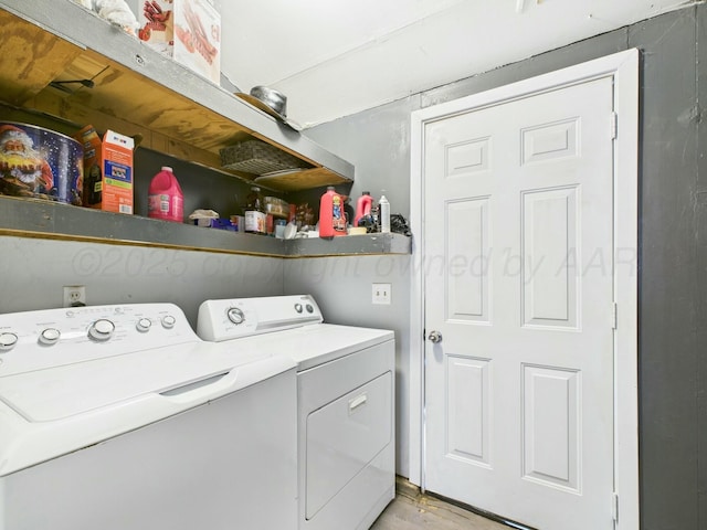 laundry room featuring light wood finished floors, washer and clothes dryer, and laundry area