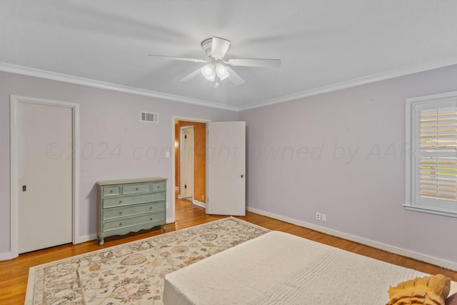 bedroom with ceiling fan, light hardwood / wood-style floors, and ornamental molding