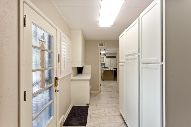 hallway featuring ornamental molding