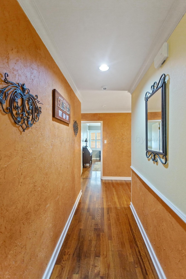 hallway with wood-type flooring and ornamental molding