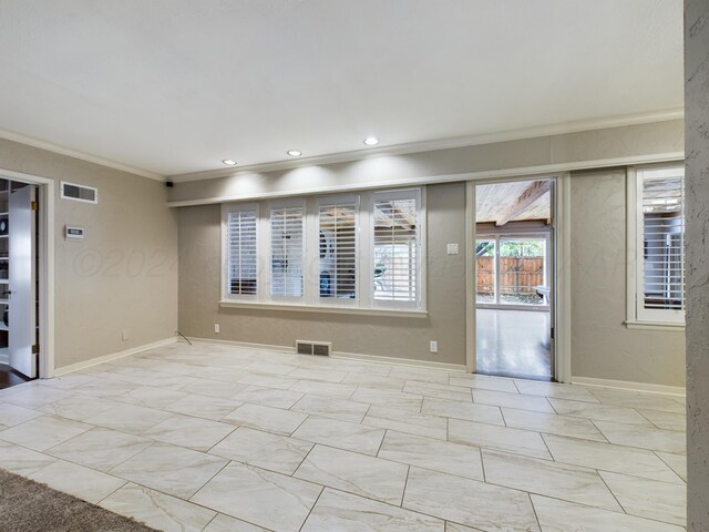 empty room featuring crown molding