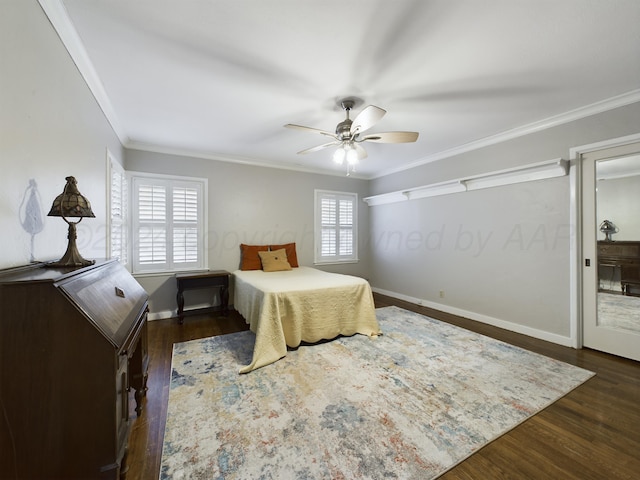 bedroom with multiple windows, dark hardwood / wood-style floors, ceiling fan, and ornamental molding