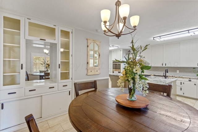 tiled dining room featuring a chandelier