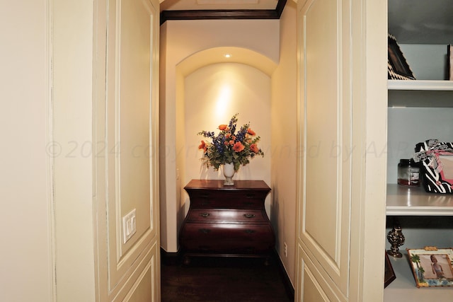 corridor featuring wood-type flooring and ornamental molding