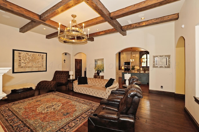 living room featuring dark wood-type flooring, beam ceiling, an inviting chandelier, and coffered ceiling