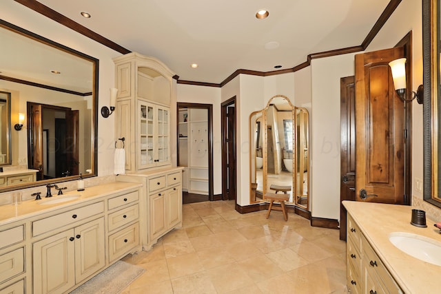 bathroom featuring vanity, tile patterned flooring, and ornamental molding