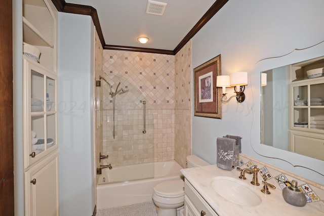 full bathroom featuring toilet, vanity, tiled shower / bath, and crown molding