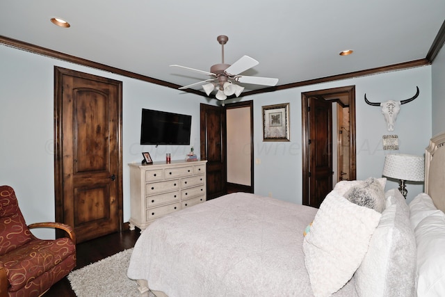 bedroom with dark wood-type flooring, ceiling fan, and crown molding