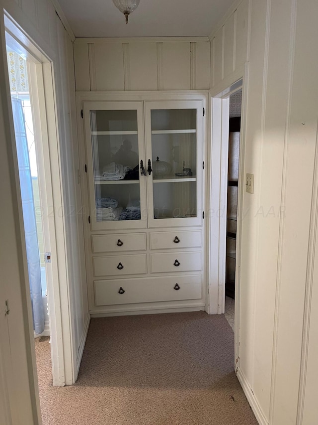 hallway with light colored carpet