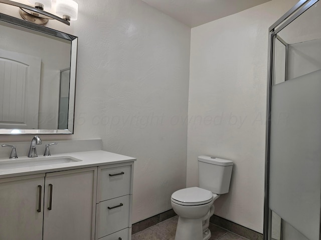 bathroom with toilet, tile patterned flooring, and vanity