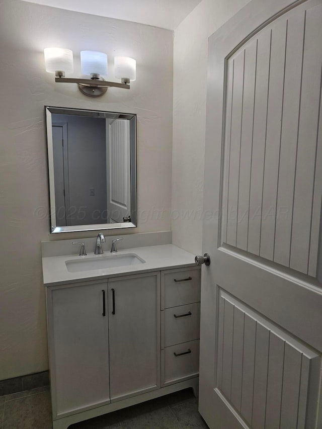 bathroom featuring tile patterned flooring and vanity